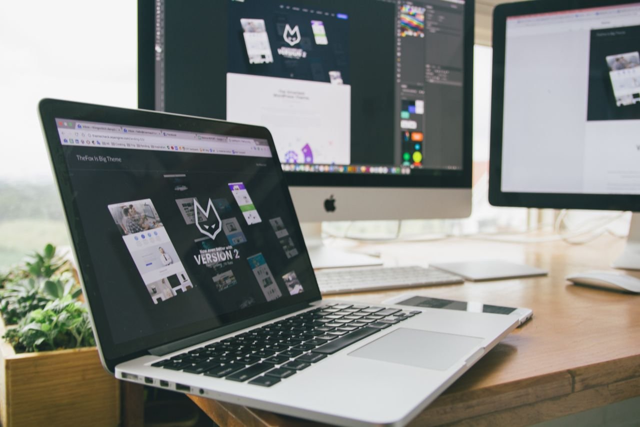 Mastering the First Impression: Your intriguing post title goes here A stylish workspace featuring a laptop and monitors displaying design software.